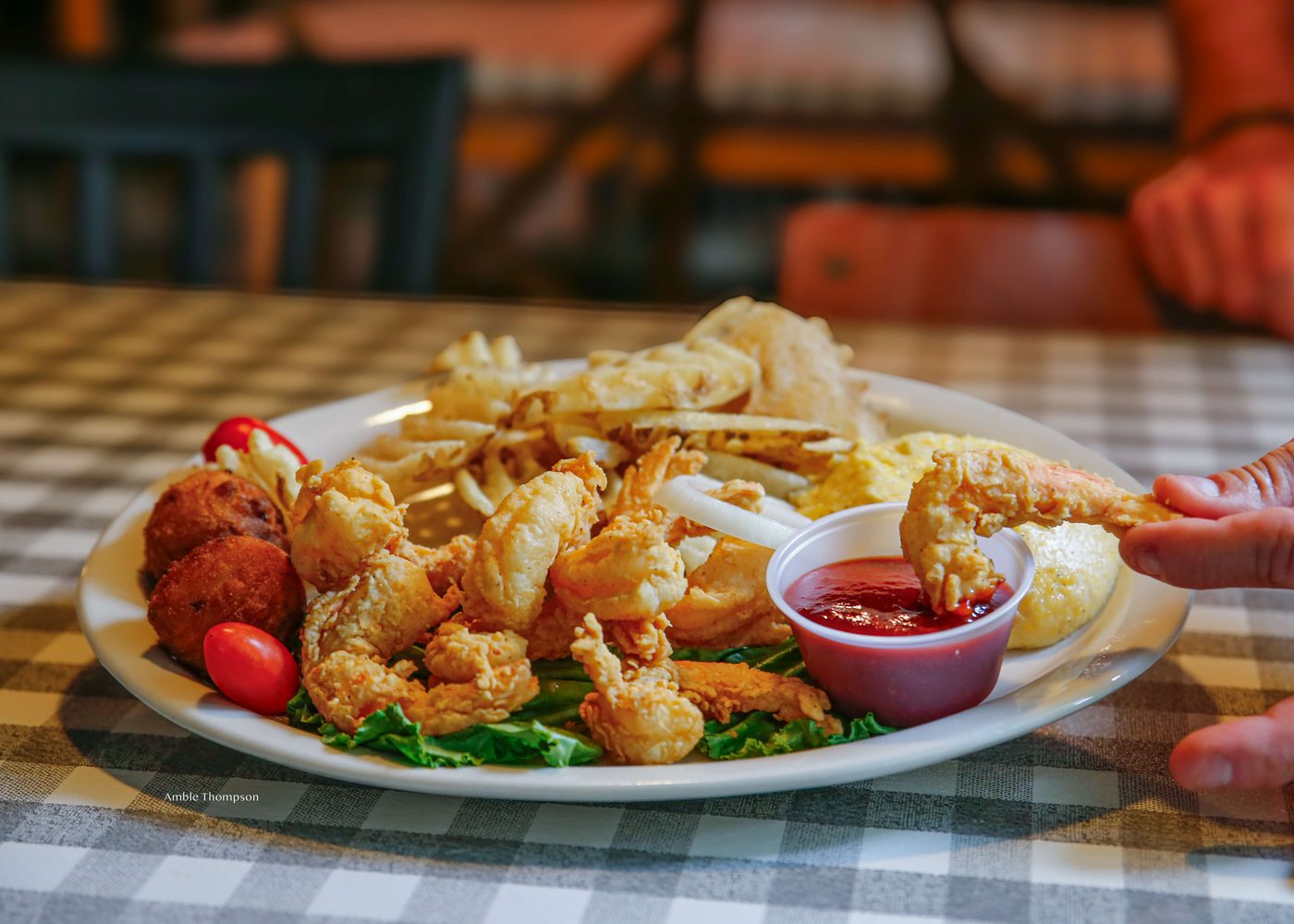 Fried shrimp plate with cocktail sauce and hushpuppies