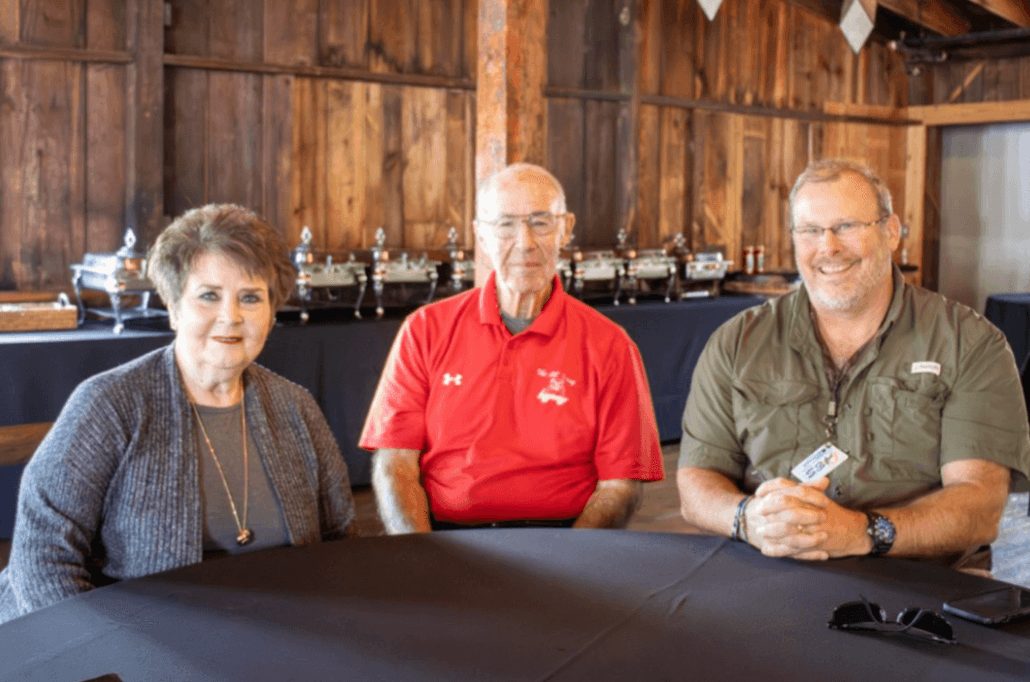 Three generations of The Little Dooey family seated at a table